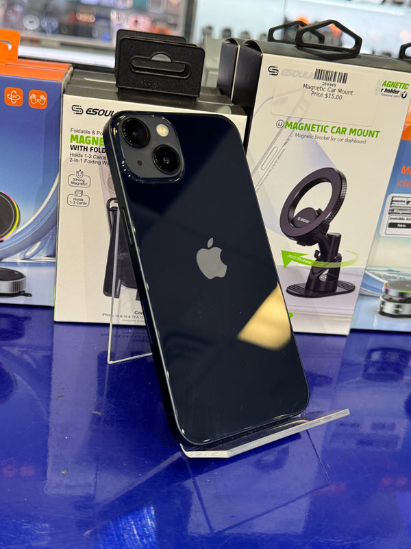 Black smartphone on a blue surface with magnetic car mount packaging in the background