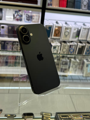 Black smartphone on a stand with a store shelf in the background