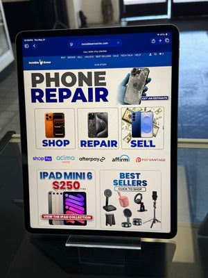 Tablet displaying a phone repair app with various repair services on the screen.