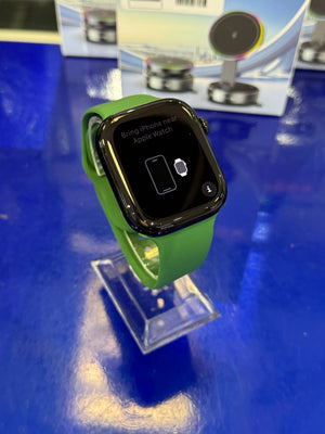 Smartwatch with a green band on a blue surface
