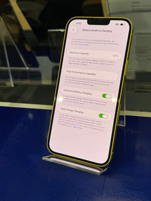 Smartphone displaying a settings screen on a reflective surface