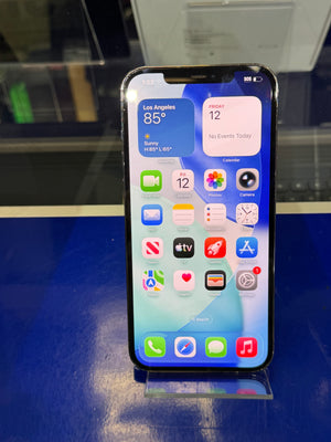 Smartphone with app icons displayed on a reflective surface