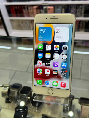 Smartphone on a stand with app icons displayed against a blurred background