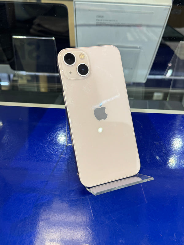 Silver iPhone on a stand with a blue surface and reflective background