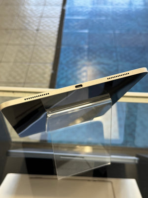 Charging port of an iPad on a reflective surface with a blurred background