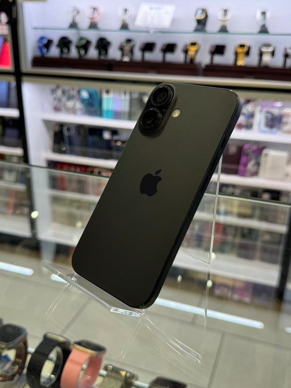 Black smartphone on a stand with a blurred store background