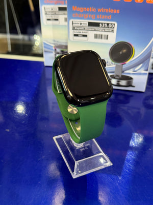 Smartwatch with green band on a blue surface