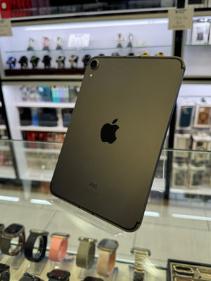 Back view of a tablet with Apple logo in a store setting