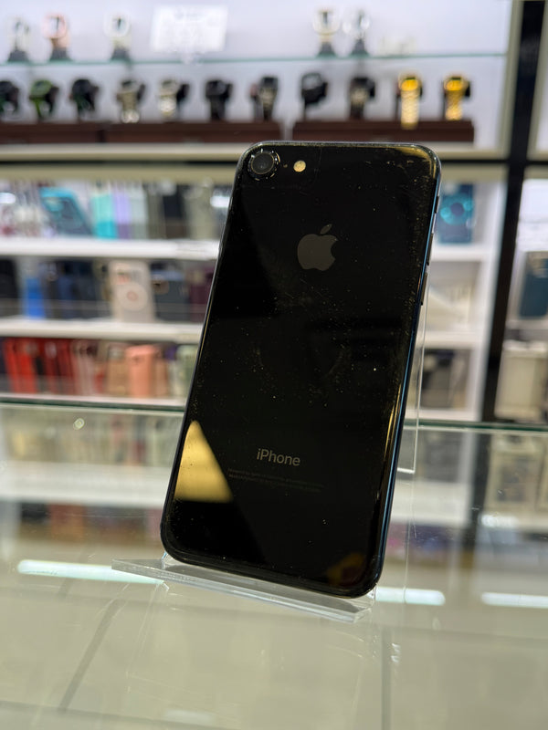 Black iPhone on a stand with blurred store interior background