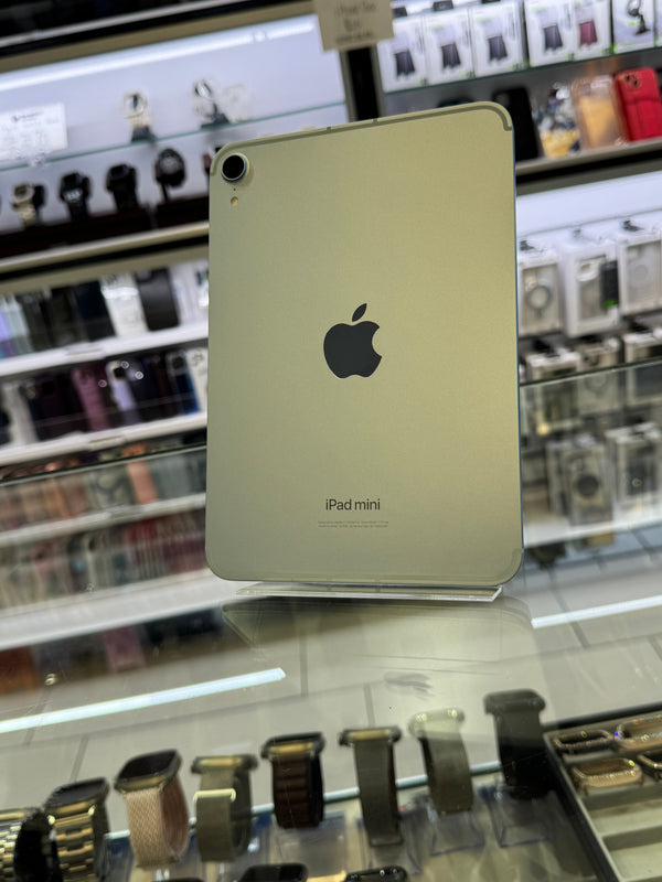 iPad mini on display in a store with blurred shelves in the background