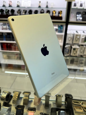 Back view of an iPad with Apple logo on a display stand.