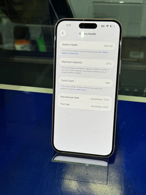Smartphone displaying battery health information on a reflective surface