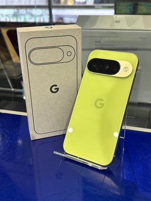 Yellow smartphone with its product packaging on a blue surface