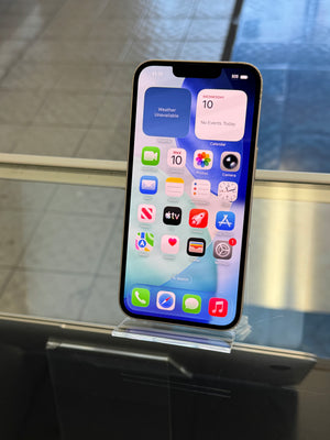 Smartphone with app icons displayed on a reflective surface