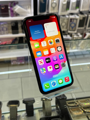 Smartphone with colorful app icons displayed on a stand in a store setting