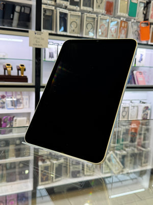 iPad held up against a blurred store window display