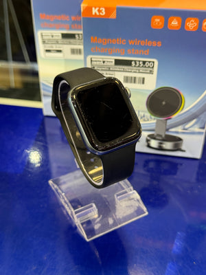 Smartwatch on a stand with a magnetic wireless charging stand box in the background