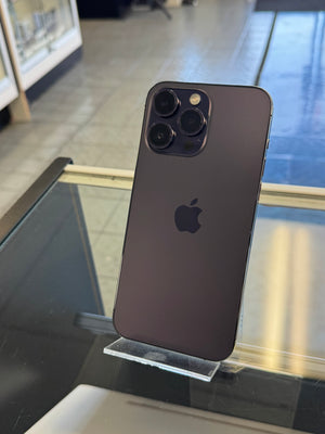 Black smartphone with Apple logo on a glass surface
