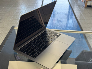 Open laptop on a glass table with a reflective surface