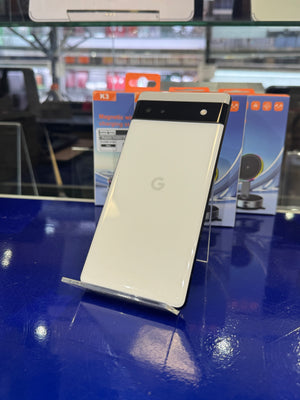 Smartphone with Google logo on a stand on a blue surface