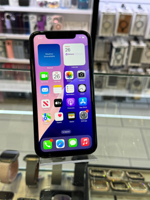 Smartphone with app icons displayed on a glass surface in a store setting
