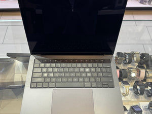 Open laptop on a glass table 