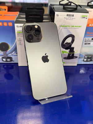 Silver iPhone with a black Apple logo on a blue surface