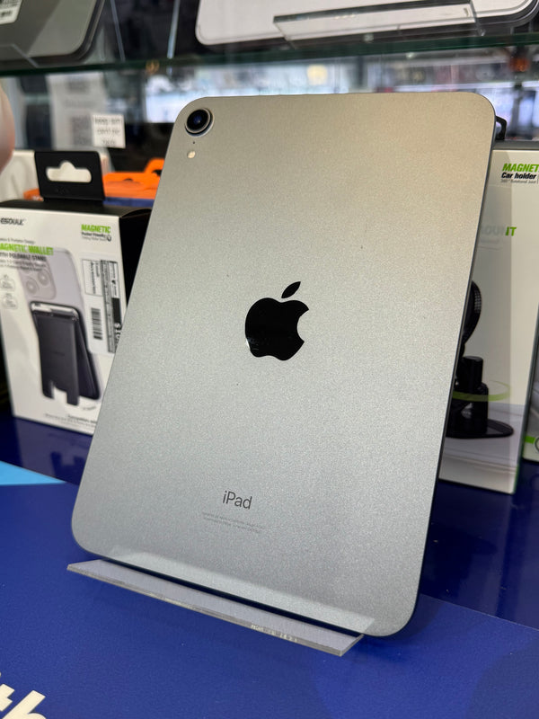 Silver iPad with Apple logo on a blue surface