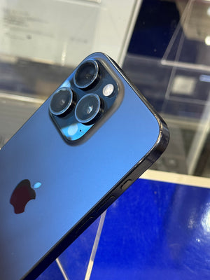 Close-up of a blue smartphone with Apple logo on a reflective surface