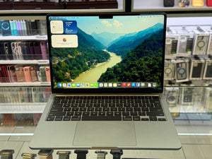 Laptop on a reflective surface with a scenic display in a store setting