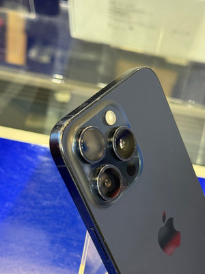 Close-up of a smartphone with camera lenses on a reflective surface