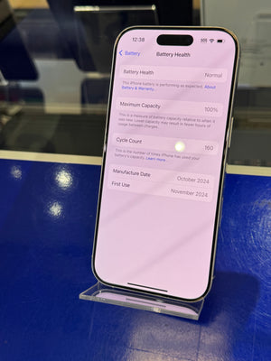 Smartphone displaying a battery health screen on a reflective surface