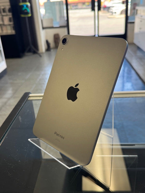 Gold tablet with Apple logo on a reflective surface
