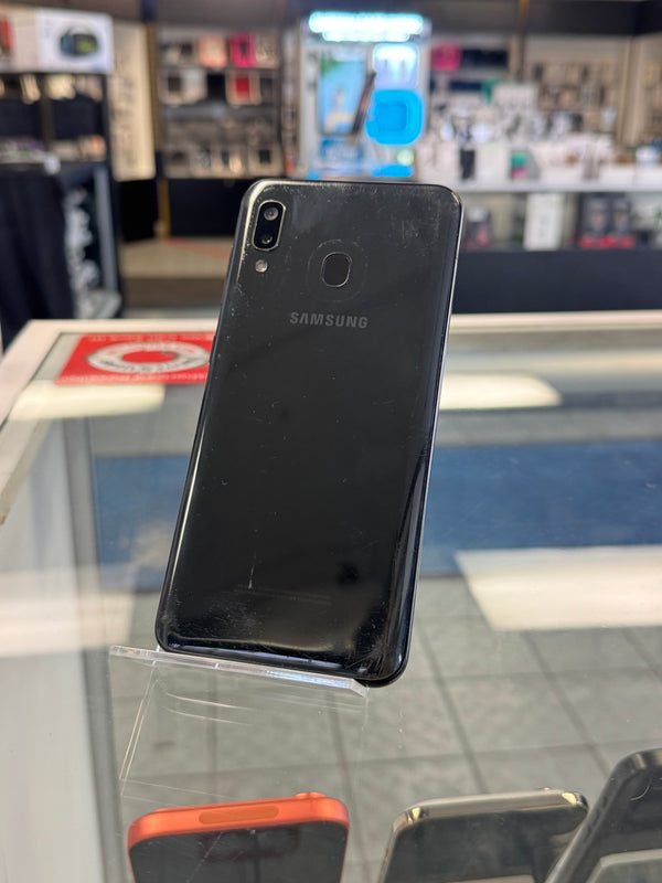 Black Samsung smartphone on a stand with a store interior background
