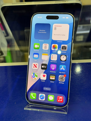 A black smartphone with a large front display showing various app icons, resting on a clear plastic display stand against a dark blue background.