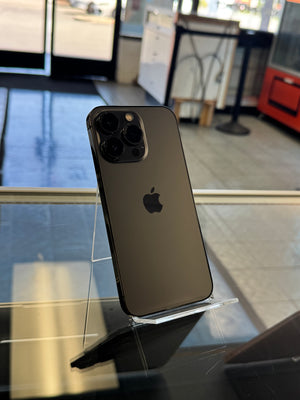 Black smartphone with Apple logo on a reflective surface