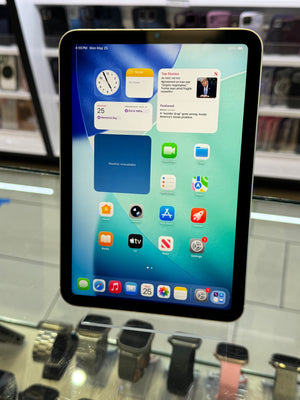 Tablet displaying a colorful home screen with various app icons in a store setting.