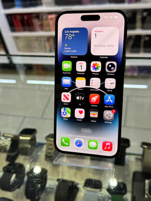 Smartphone with app icons displayed on a stand in a store setting