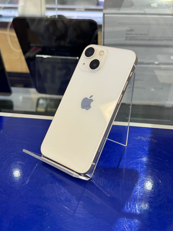 Smartphone with Apple logo on a clear stand against a blue background