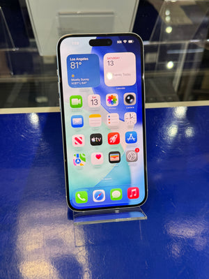 Smartphone with app icons displayed on a reflective blue surface