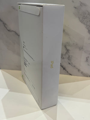 A white Apple iPad box with "iPad" text on the side photographed on a white marble-patterned surface.