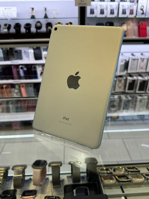 Back view of an iPad with Apple logo on a technical equipment background