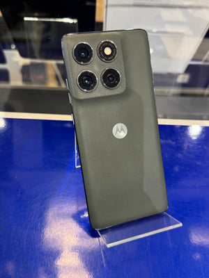 Motorola smartphone on a stand with a blue surface in the background