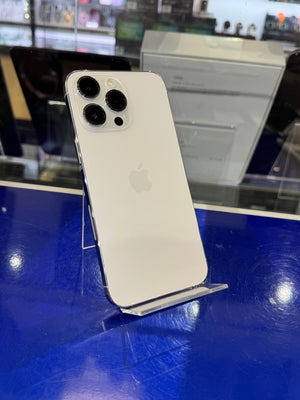 White smartphone on a stand with a blurred store interior background