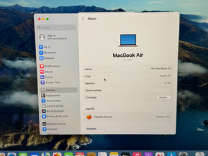 MacBook Air specifications window on a mountainous landscape background