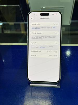 Smartphone displaying battery health information on a reflective surface