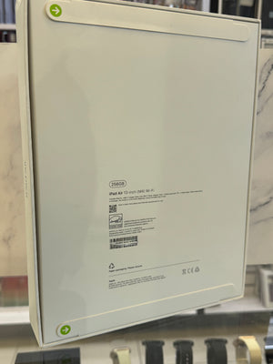 The back of a white Apple iPad Air 13-inch Wi-Fi tablet, showing the model number T2560 and regulatory text, displayed on a retail stand.