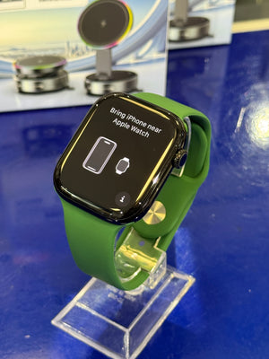 Smartwatch with a green band on a blue background