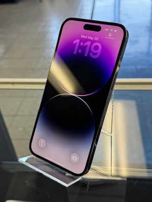Smartphone with a reflective screen on a stand, displaying a colorful display.