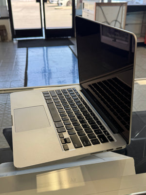 Open laptop on a reflective surface with blurred background